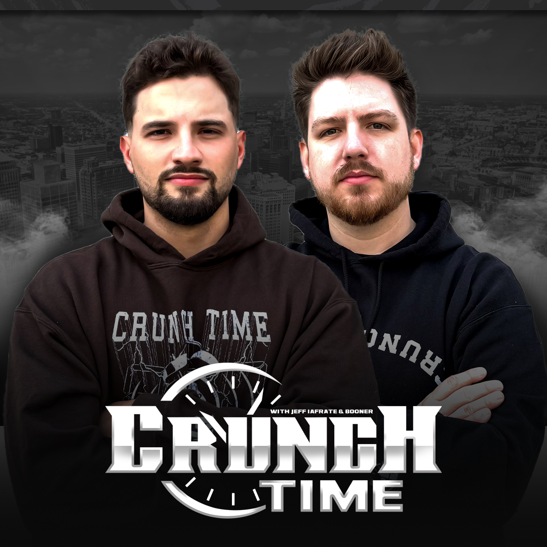 Two men in dark hoodies pose in front of a grayscale cityscape with a bold'Crunch Time' logo at the bottom.